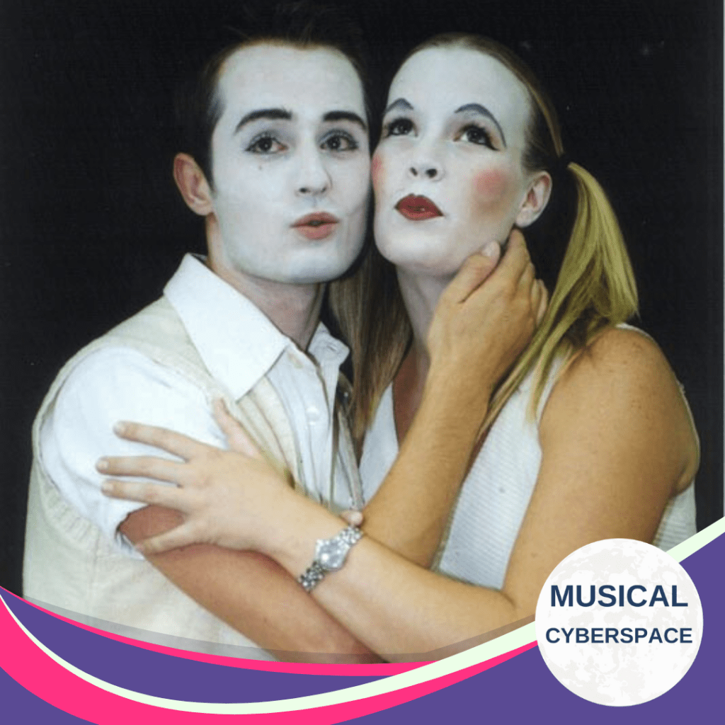 Two actors portraying Matt and Luisa in UCT’s 2002 student production of The Fantasticks, both wearing pale makeup with exaggerated blush and eyeliner. The pair pose closely in a stylised, romantic expression, evoking a dreamy theatrical tone.