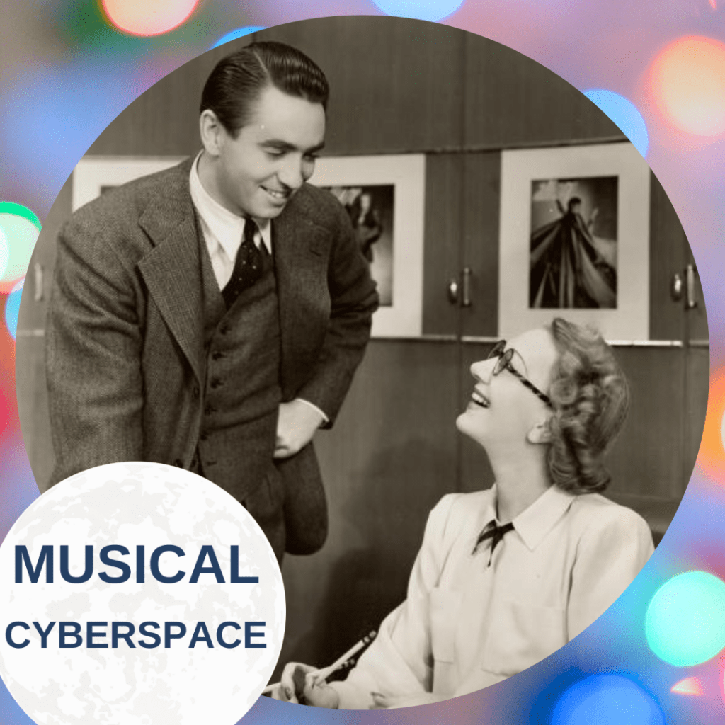 A smiling Macdonald Carey (as Charley Johnson) leans over the desk of Gertrude Lawrence (as Liza Elliott), who wears glasses and a light blouse. Both actors are mid-conversation in a smartly furnished 1940s office in LADY IN THE DARK, framed by a festive circular border and “Musical Cyberspace” logo.