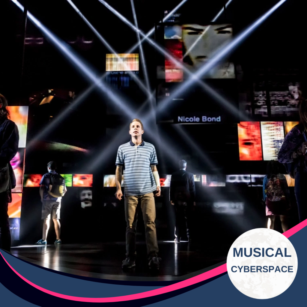 A young man in a striped polo shirt stands centre stage, looking upward as beams of white light cross over a wall of digital screens showing faces and names, evoking social-media posts, in a scene from the musical DEAR EVAN HANSEN.