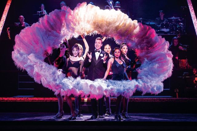 Jonathan Roxmouth as Billy Flynn with the company of the 2025 South African production of CHICAGO